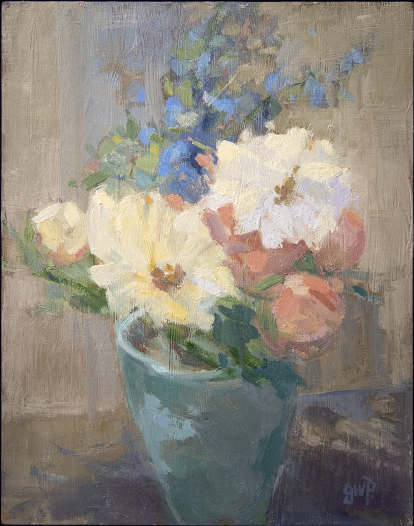 Still life with white and peach flowers in a blue vase.